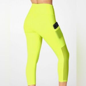 Fabletics Mila High-Waisted Pocket Capri Leggings in Neon